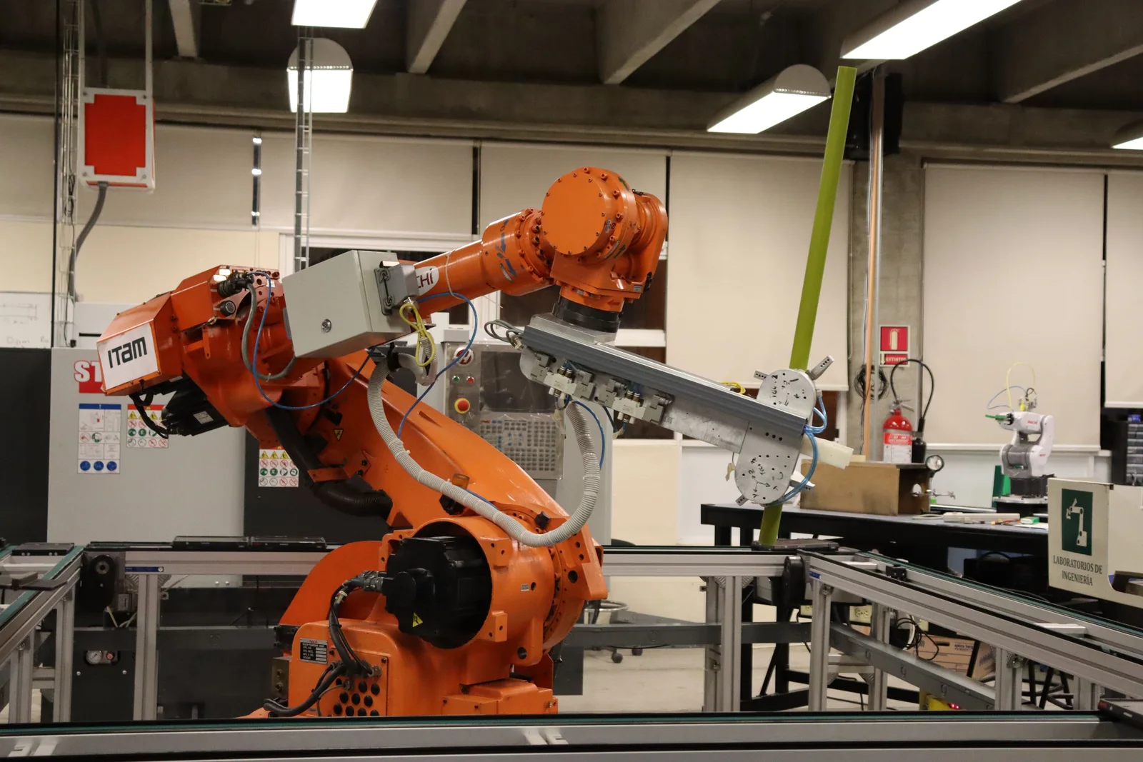 Orange industrial robot arm on an automated line